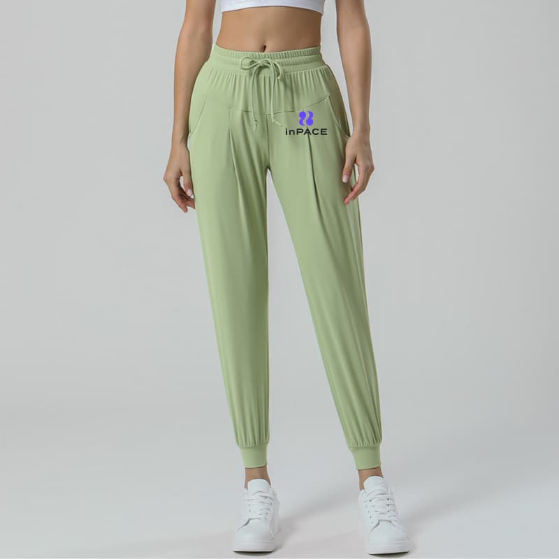 Green drawstring pocket activewear joggers front view for private-label gym wear development