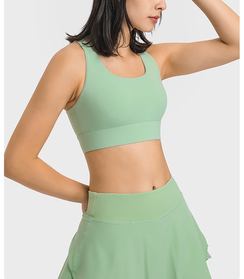 Mint sports bra shown from the front with a coordinated skirt as a catalogue reference