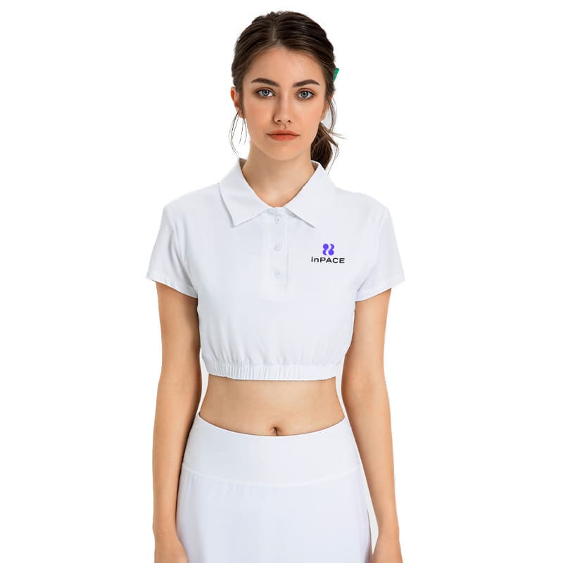 White cropped performance polo top with collar, button placket, and elastic hem