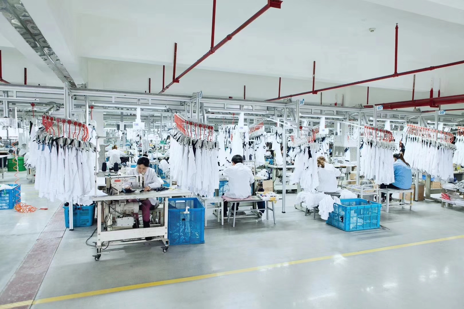 Garment production floor with sewing workstations and work in progress