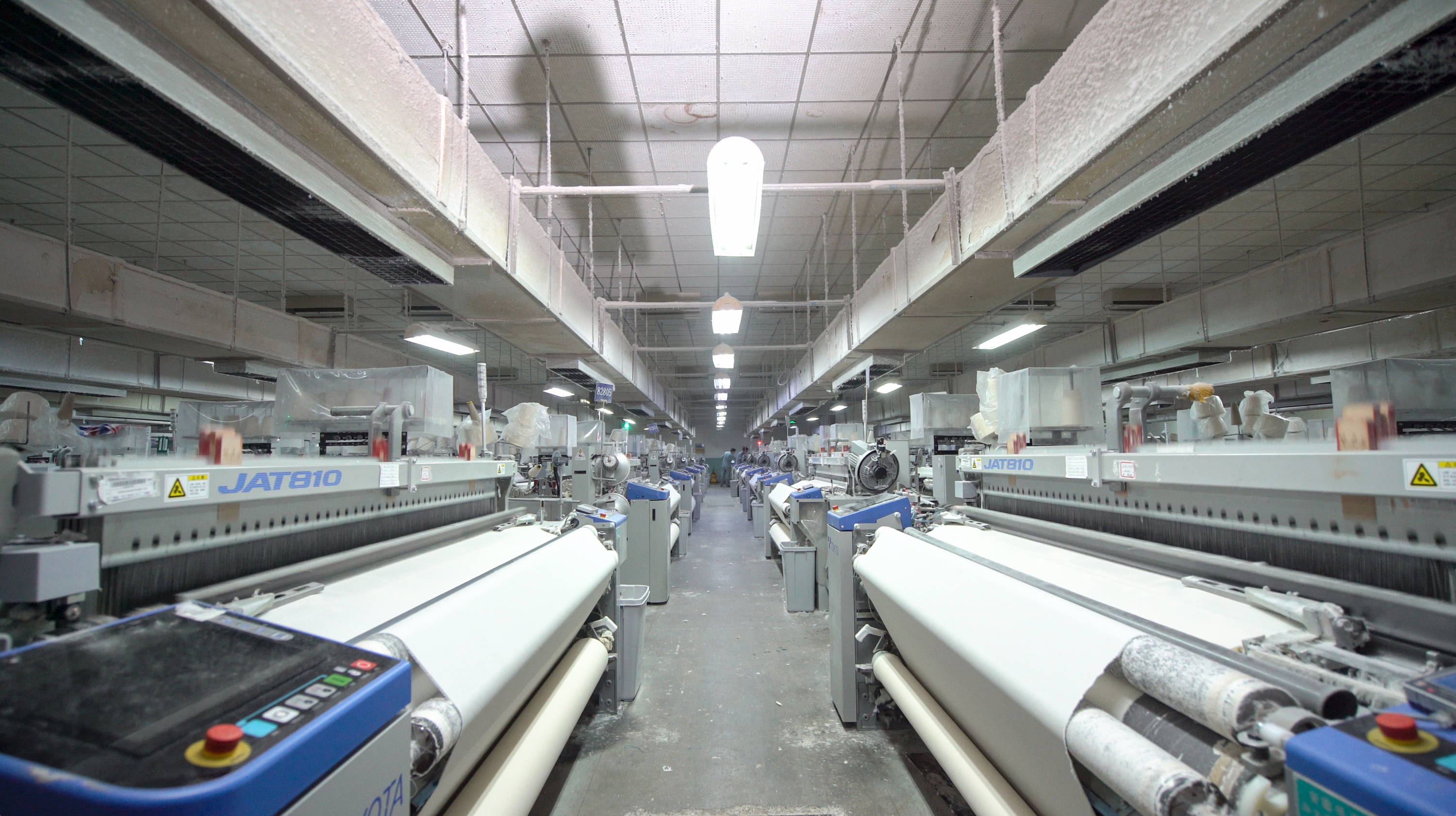 Fabric production equipment processing textile material for garment development